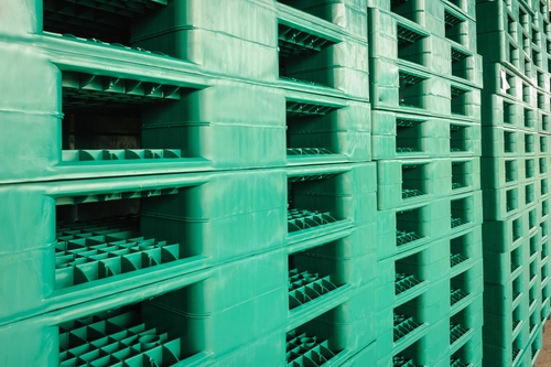 Green plastic pallets in warehouse
