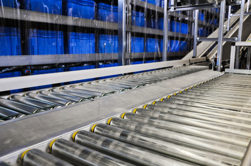 Conveyer-belt-showing-blue-plastic-shipping-containers