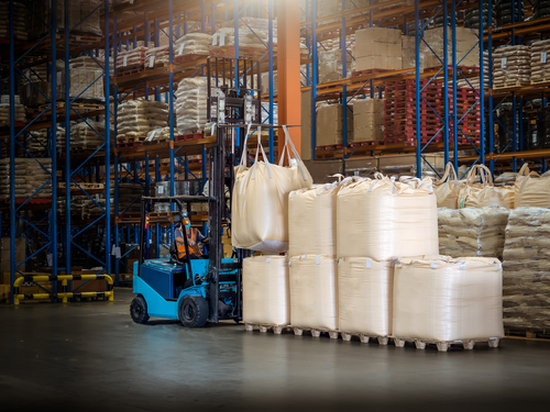forklift handling jumbo bags in warehouse