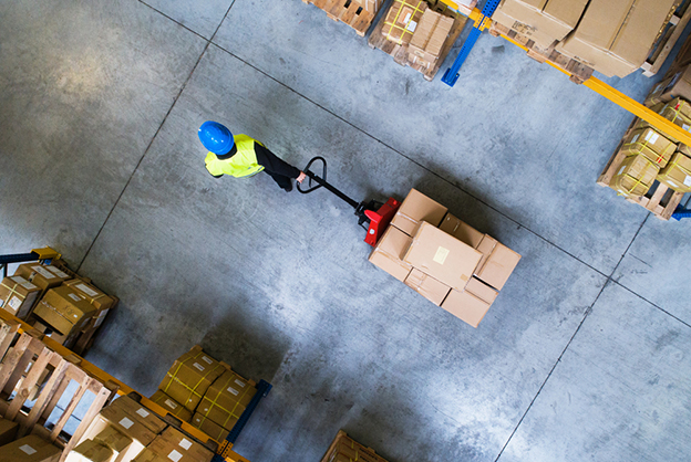 warehouse worker pulling pallet truck