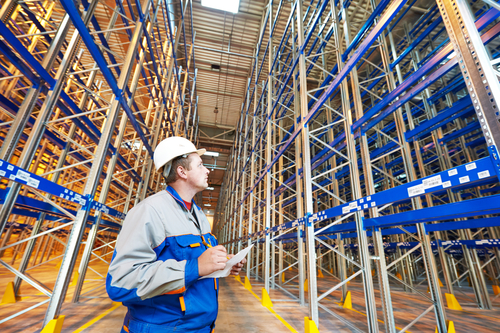 warehouse worker in front of stack racks