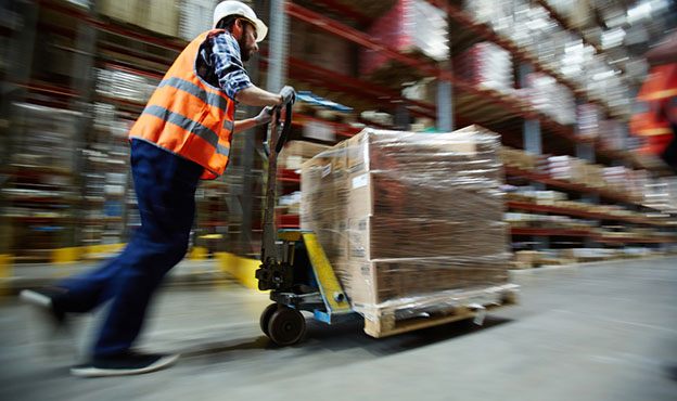  man pushing package in warehouse