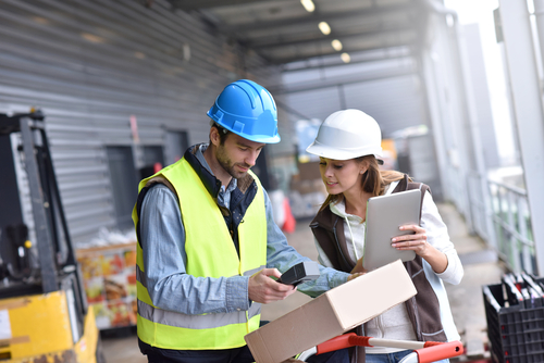 Store manager with warehouseman checking goods reception