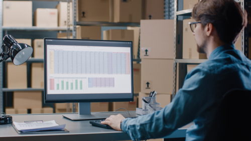 warehouse manager checking shipping spreadsheet