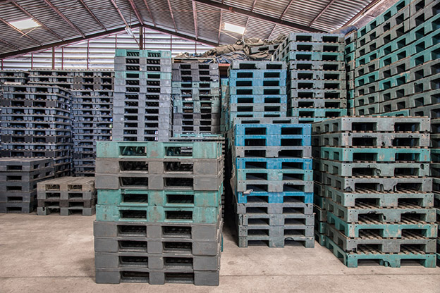 Stacks of plastic pallets in a warehouse