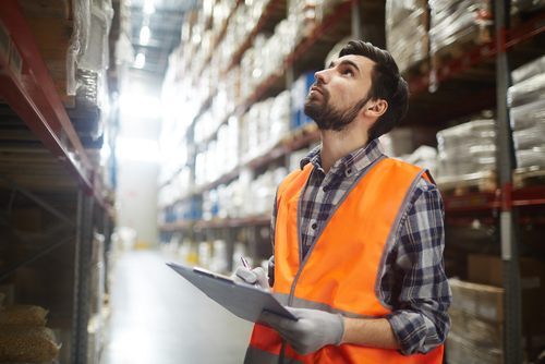 manager reviewing warehouse inventory
