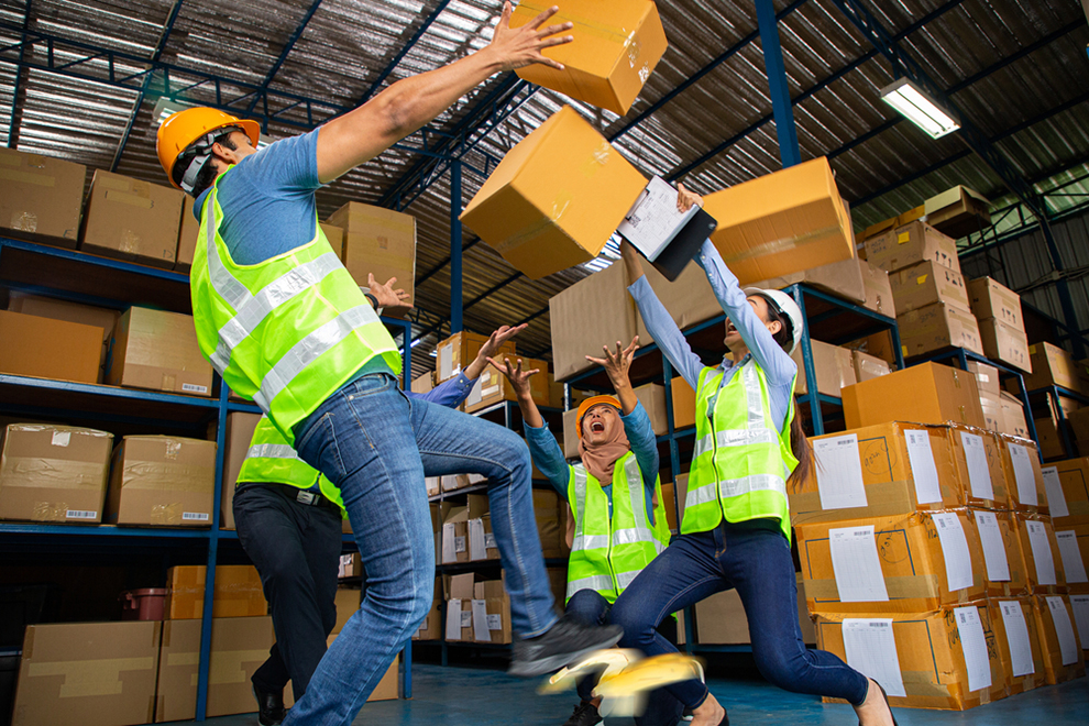 warehouse workers with boxes falling on them