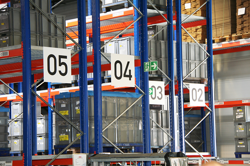 a few aisles of stack racks in an industrial warehouse