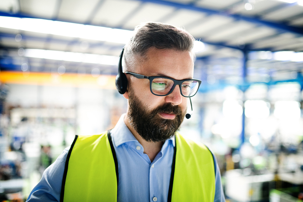 a technician with a high vis vest and a headset
