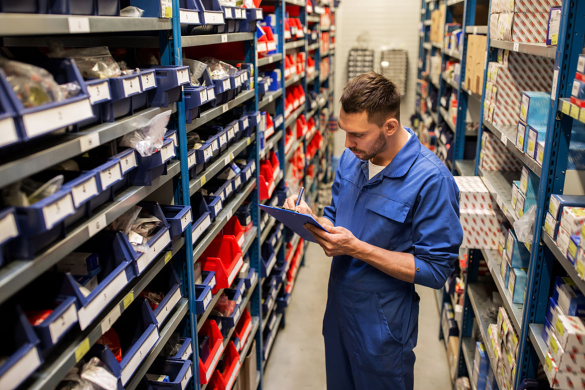 a worker doing inventory of parts in an auto store