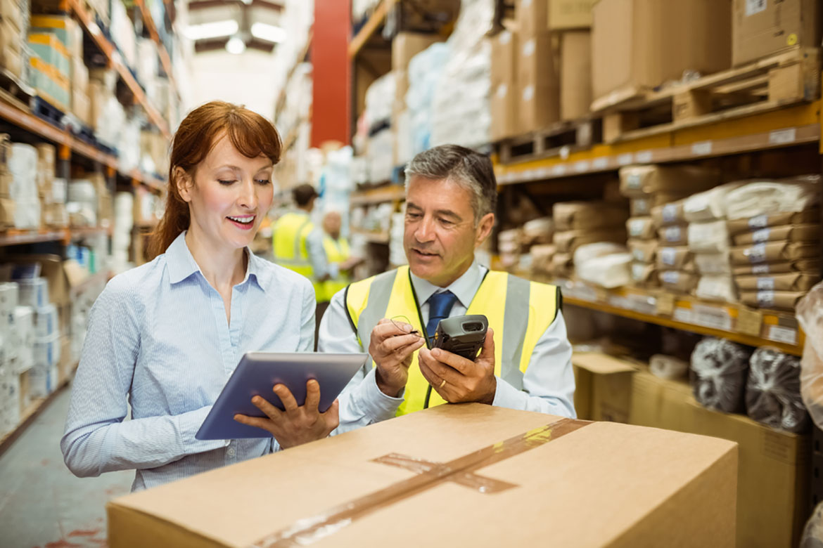 a couple of employees working in a warehouse