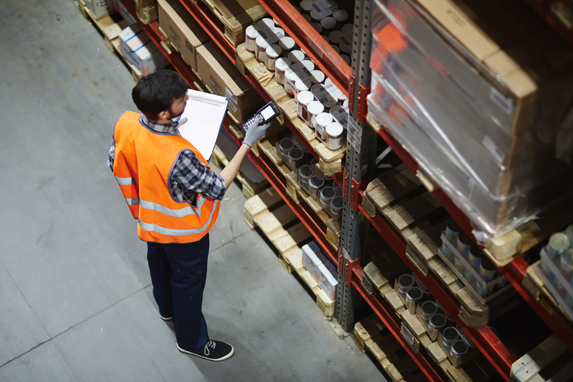 a worker scanning products in a warehouse