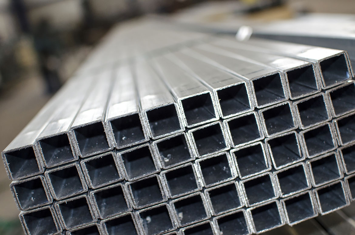 a close-up of a stack of square sheet metal tubing