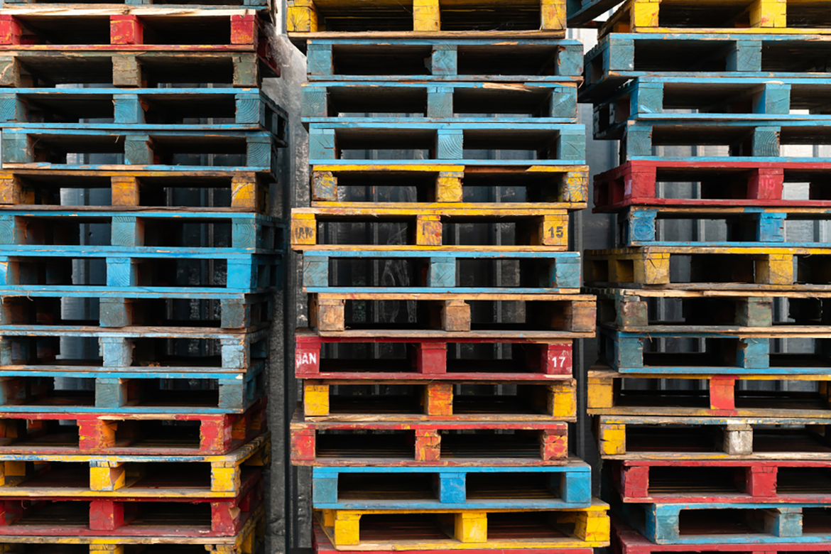 a close up of three stacks of multicolored wood pallets