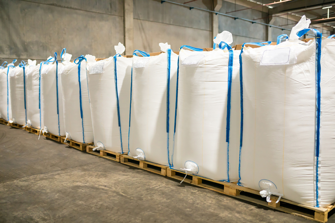 a row of large white sacks on pallets