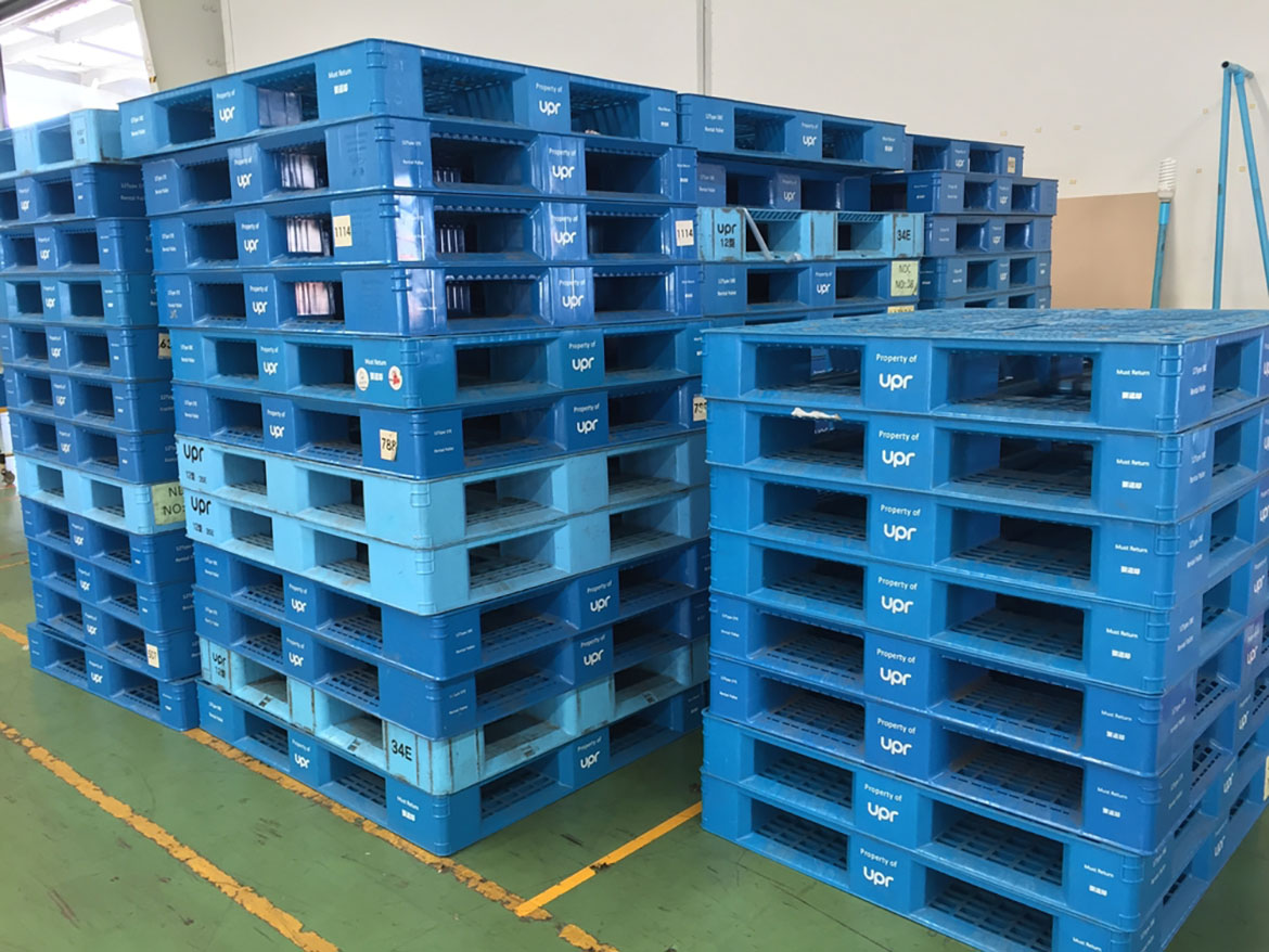 Stacks of blue plastic pallets