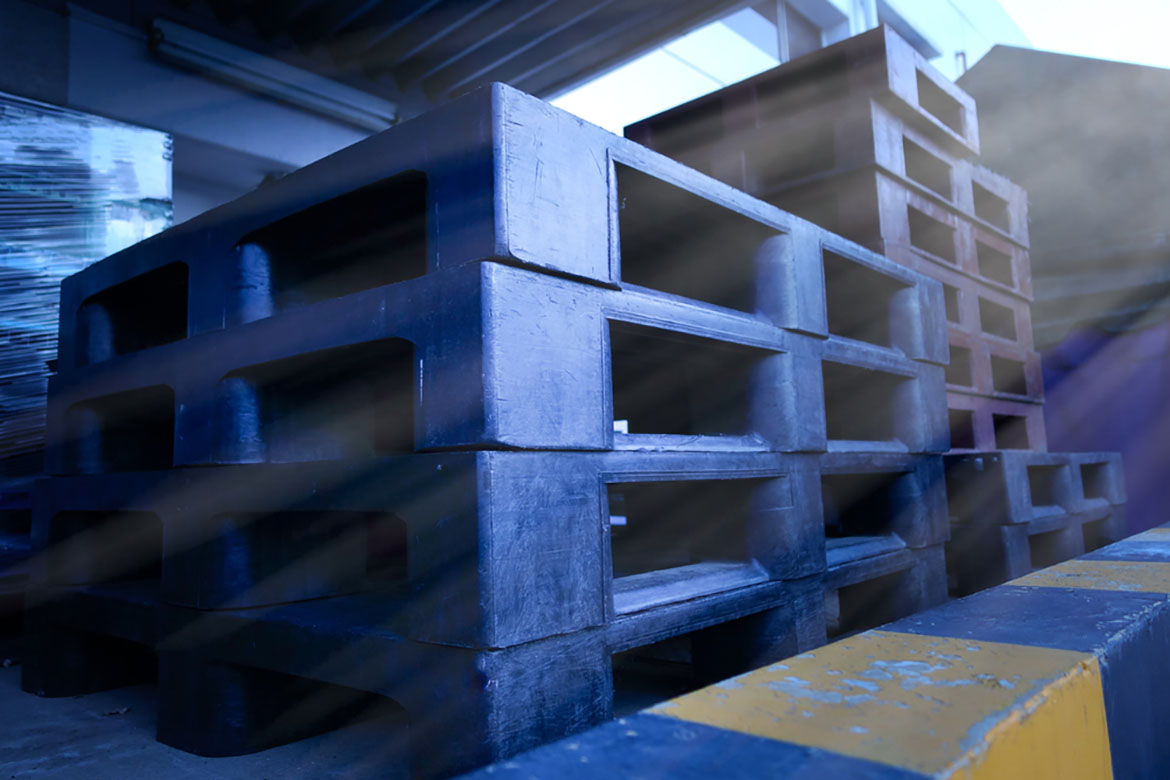 closeup blue plastic pallets in warehouse