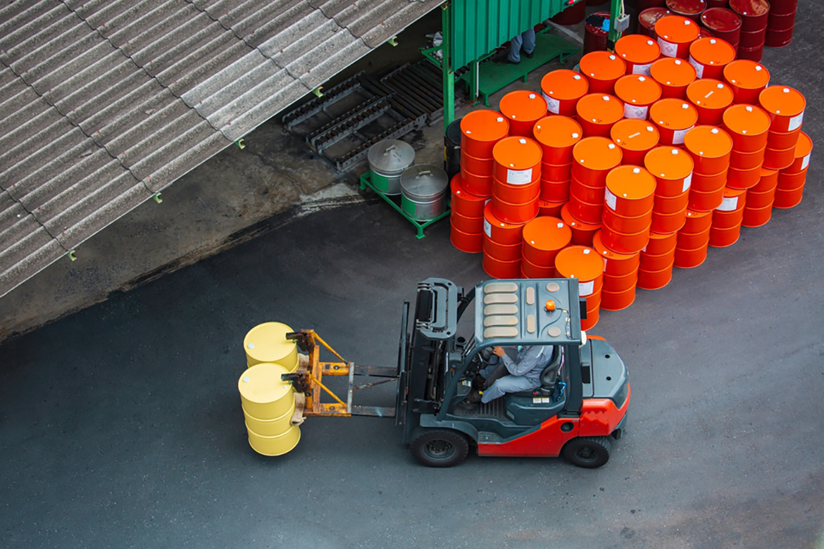 a top down view of a forklift stacking oil barrels
