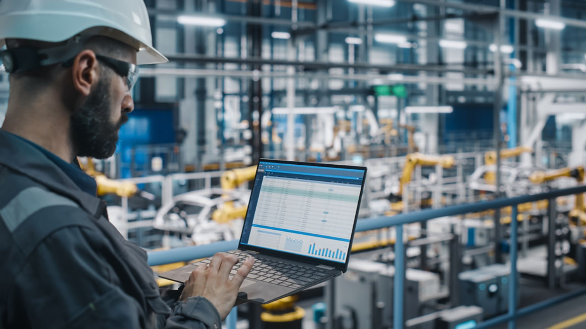 engineer reviewing spreadsheet on laptop