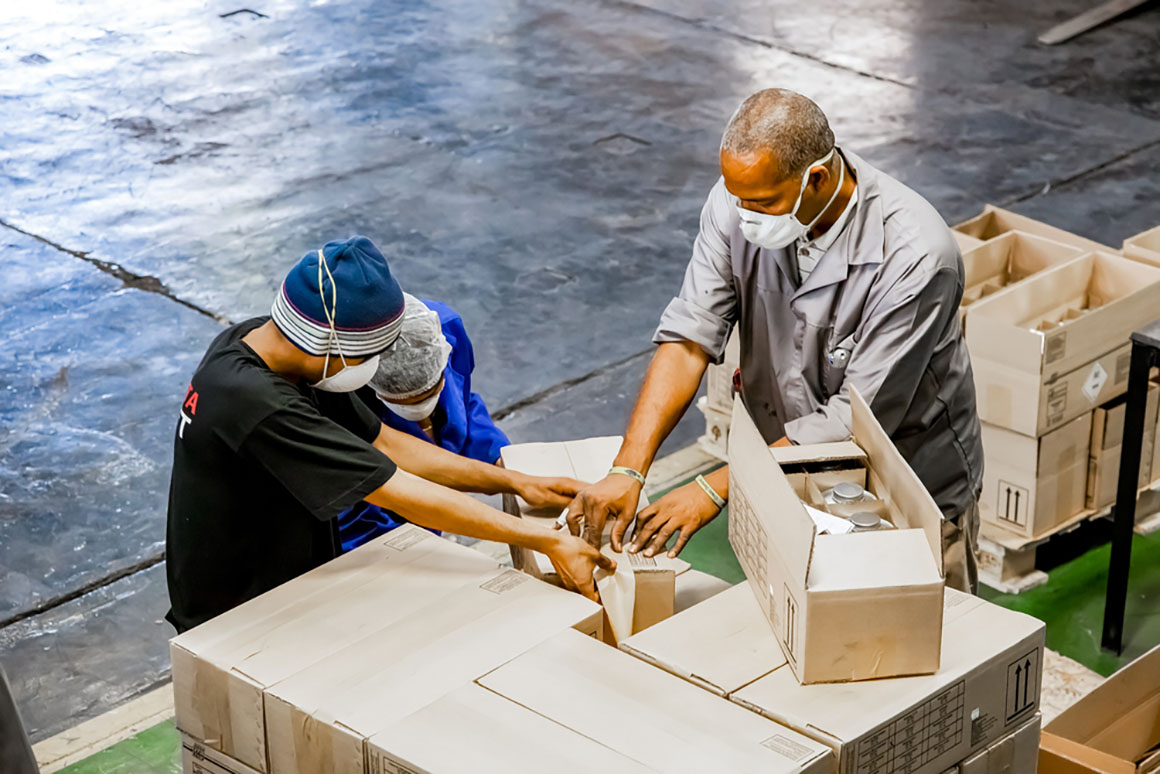 workers packing boxes in warehouse